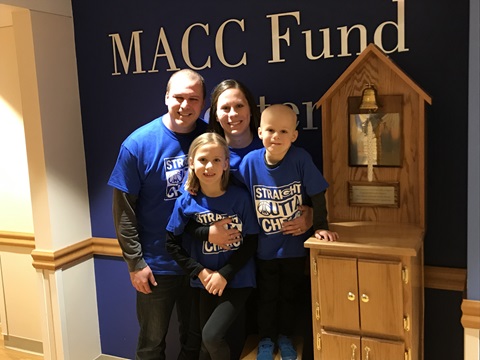 Dylan P with his family ringing the MACC Fund bell
