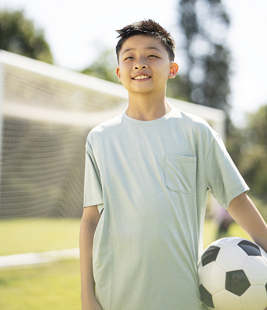 Kid holding soccer ball.